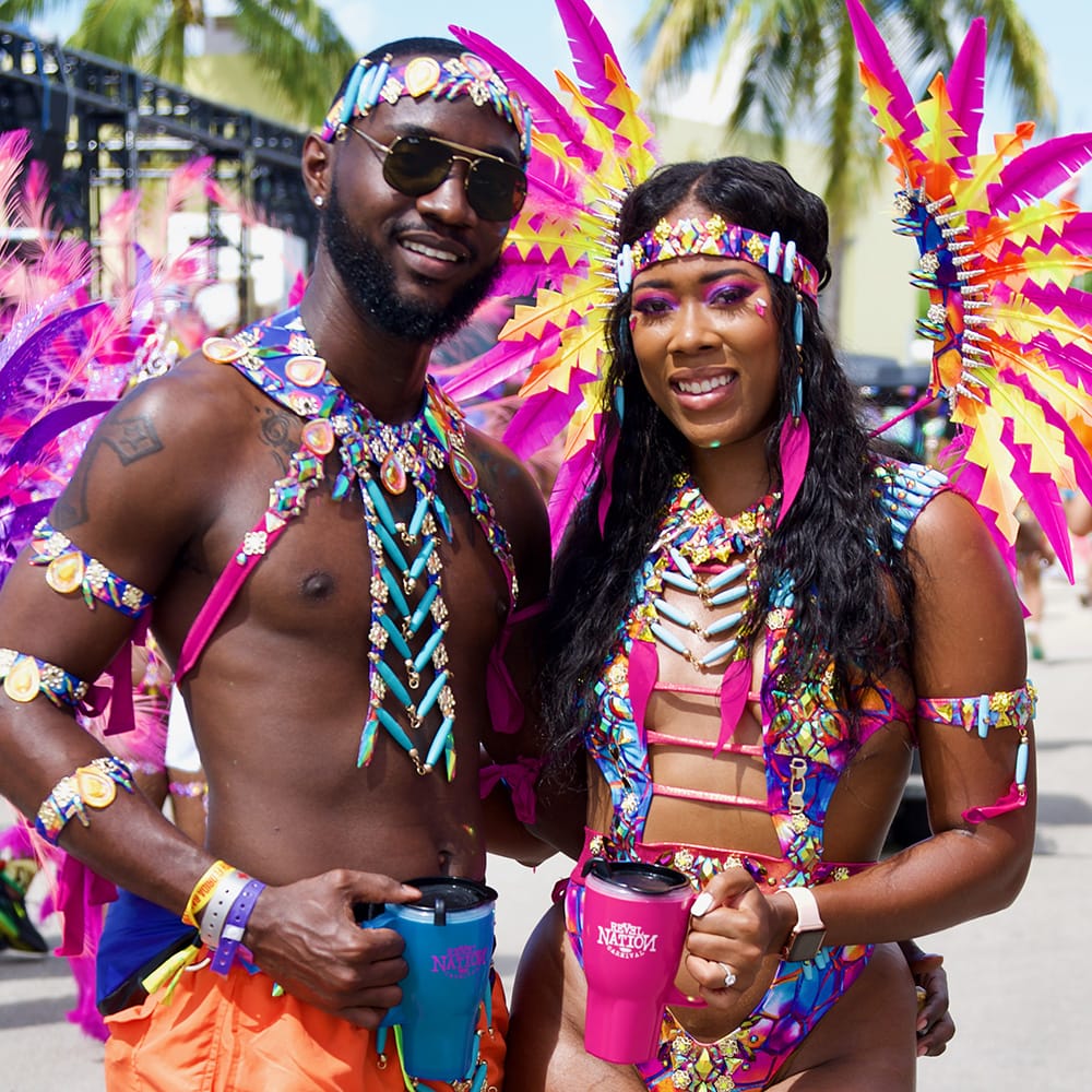man and woman in colorful carnival attire